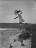 unidentified small girl leaping onto the beach, c. 1930s, by Sam Hood by State Library of New South Wales collection