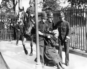 campaigning-suffragette-being-restrained-by-policemen-5-july-1910